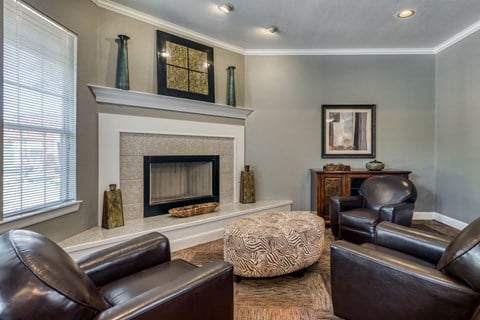 a living room with leather furniture and a fireplace